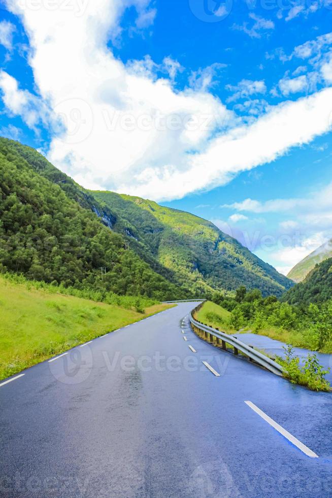 Beautiful wet road the mountains cloudy sky of Norway. photo
