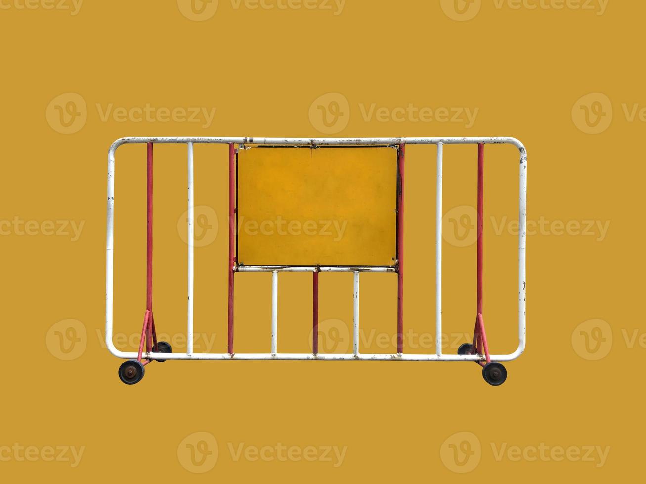 Old traffic steel fence with a wheel and yellow label on a yellow background with clipping path photo