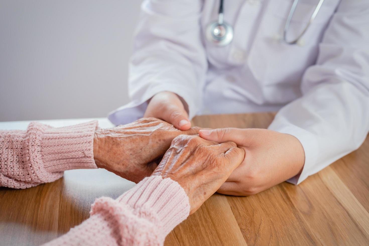 The doctor shook the patient's hand as a sign of encouragement. photo