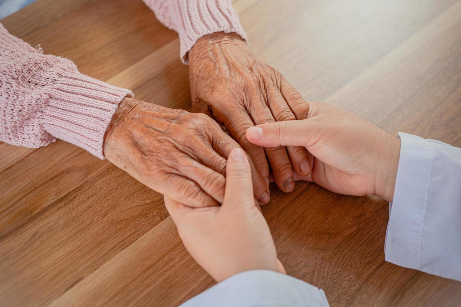 The doctor shook the patient's hand as a sign of encouragement. photo