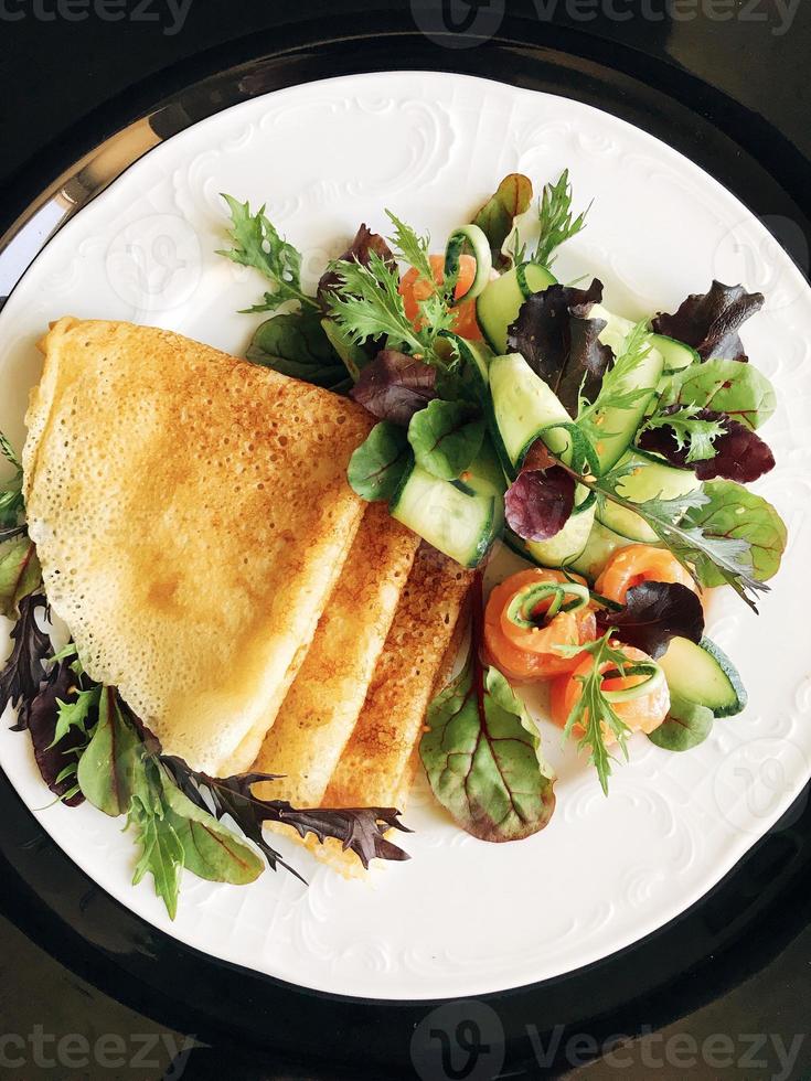 Health food pancakes with salad and salmon photo
