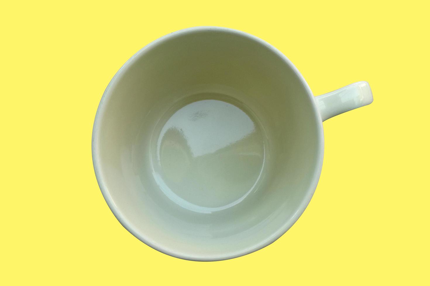 cream coffee cup isolate on yellow background. photo