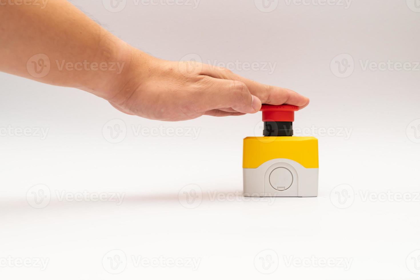 Stop Red Button and the Hand of Worker About to Press it. emergency stop button. Big Red emergency button or stop button for manual pressing. photo
