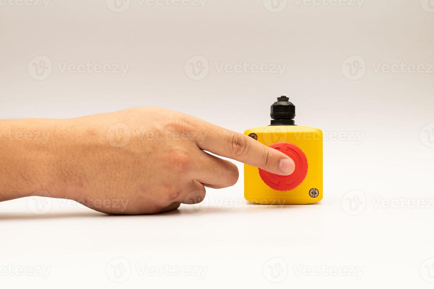 Stop Red Button and the Hand of Worker About to Press it. emergency stop button. Big Red emergency button or stop button for manual pressing. photo