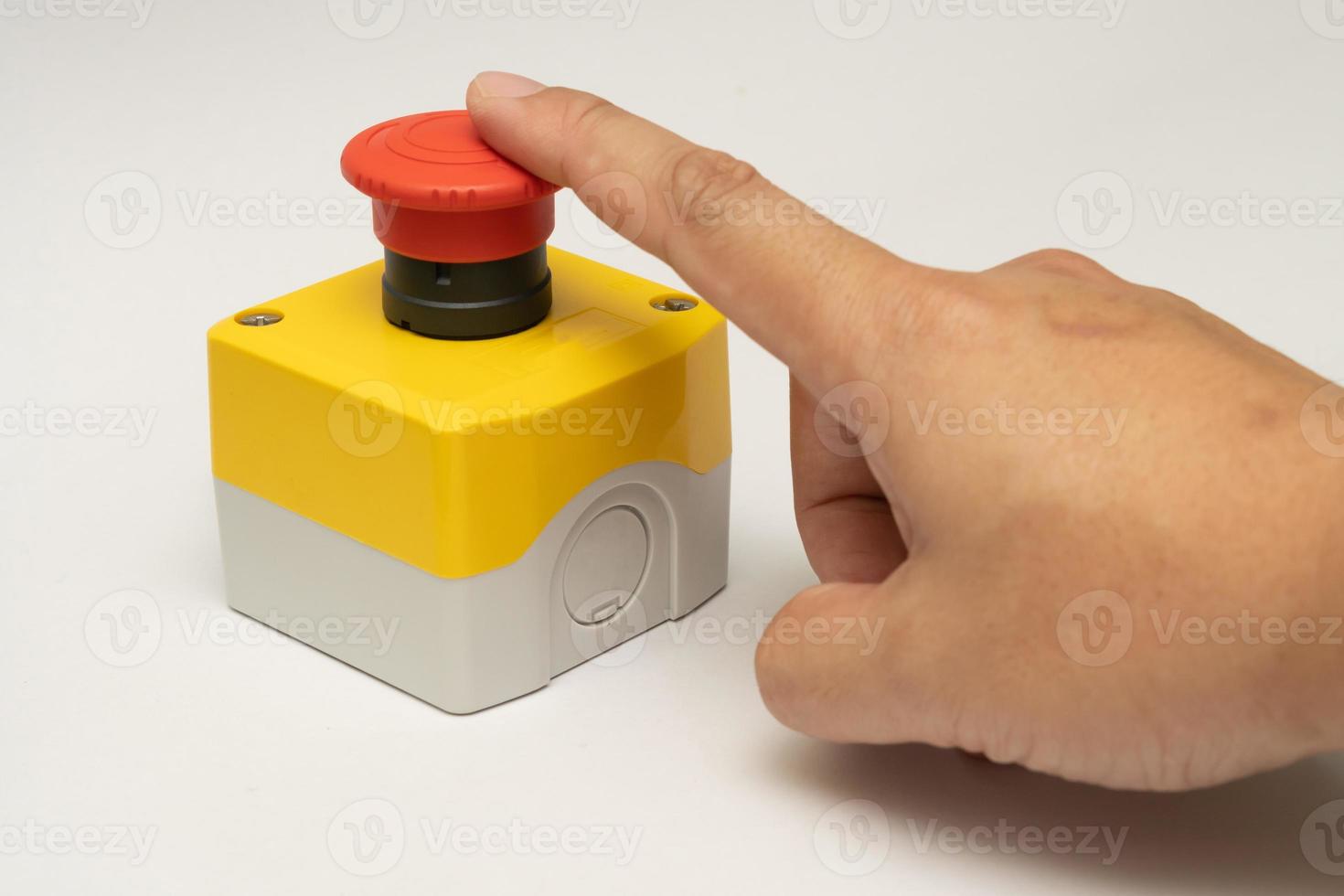 Stop Red Button and the Hand of Worker About to Press it. emergency stop button. Big Red emergency button or stop button for manual pressing. photo