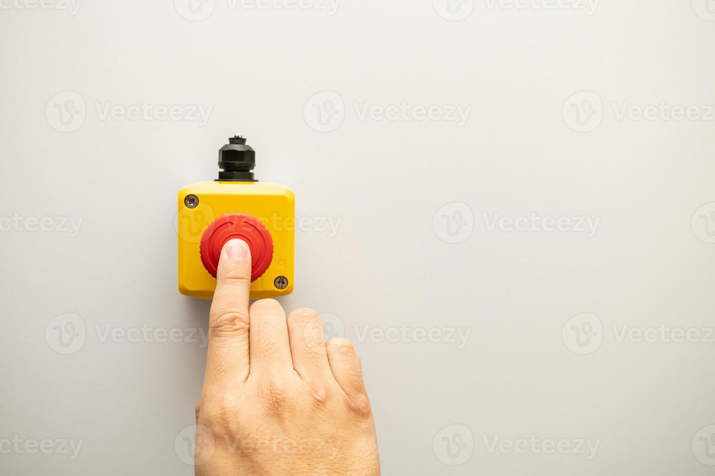 Stop Red Button and the Hand of Worker About to Press it. emergency stop button. Big Red emergency button or stop button for manual pressing. photo