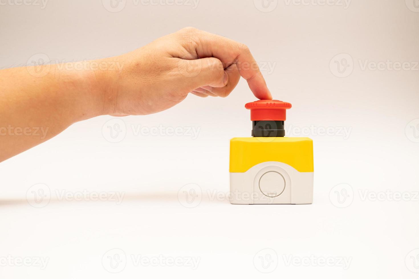 Stop Red Button and the Hand of Worker About to Press it. emergency stop button. Big Red emergency button or stop button for manual pressing. photo