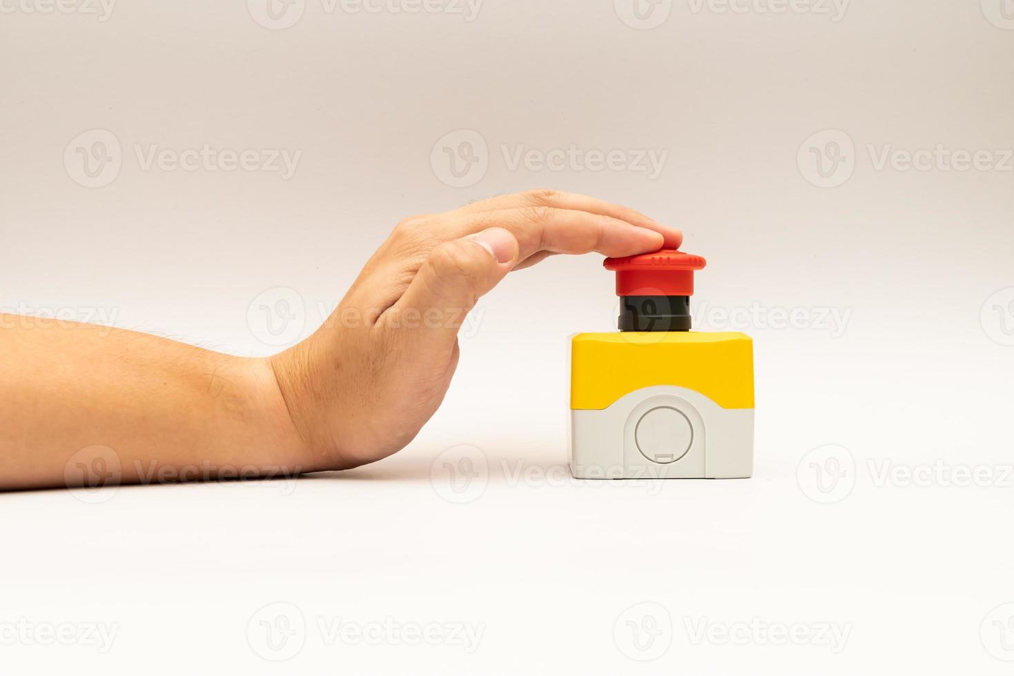 Stop Red Button and the Hand of Worker About to Press it. emergency stop button. Big Red emergency button or stop button for manual pressing. photo