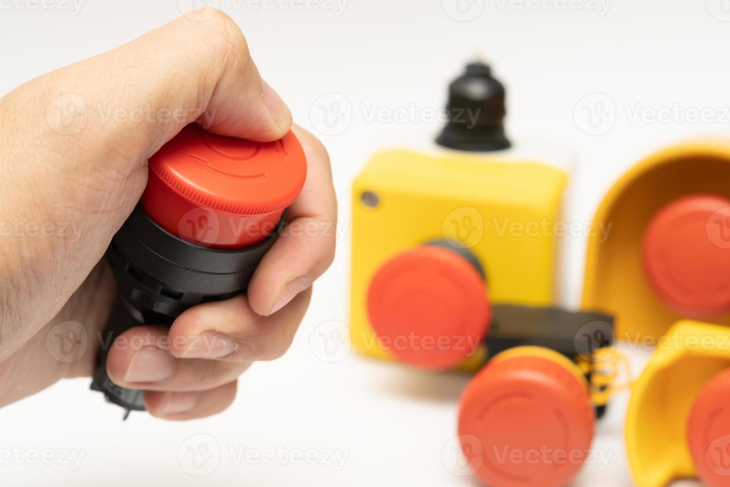 Stop Red Button and the Hand of Worker About to Press it. emergency stop button. Big Red emergency button or stop button for manual pressing. photo