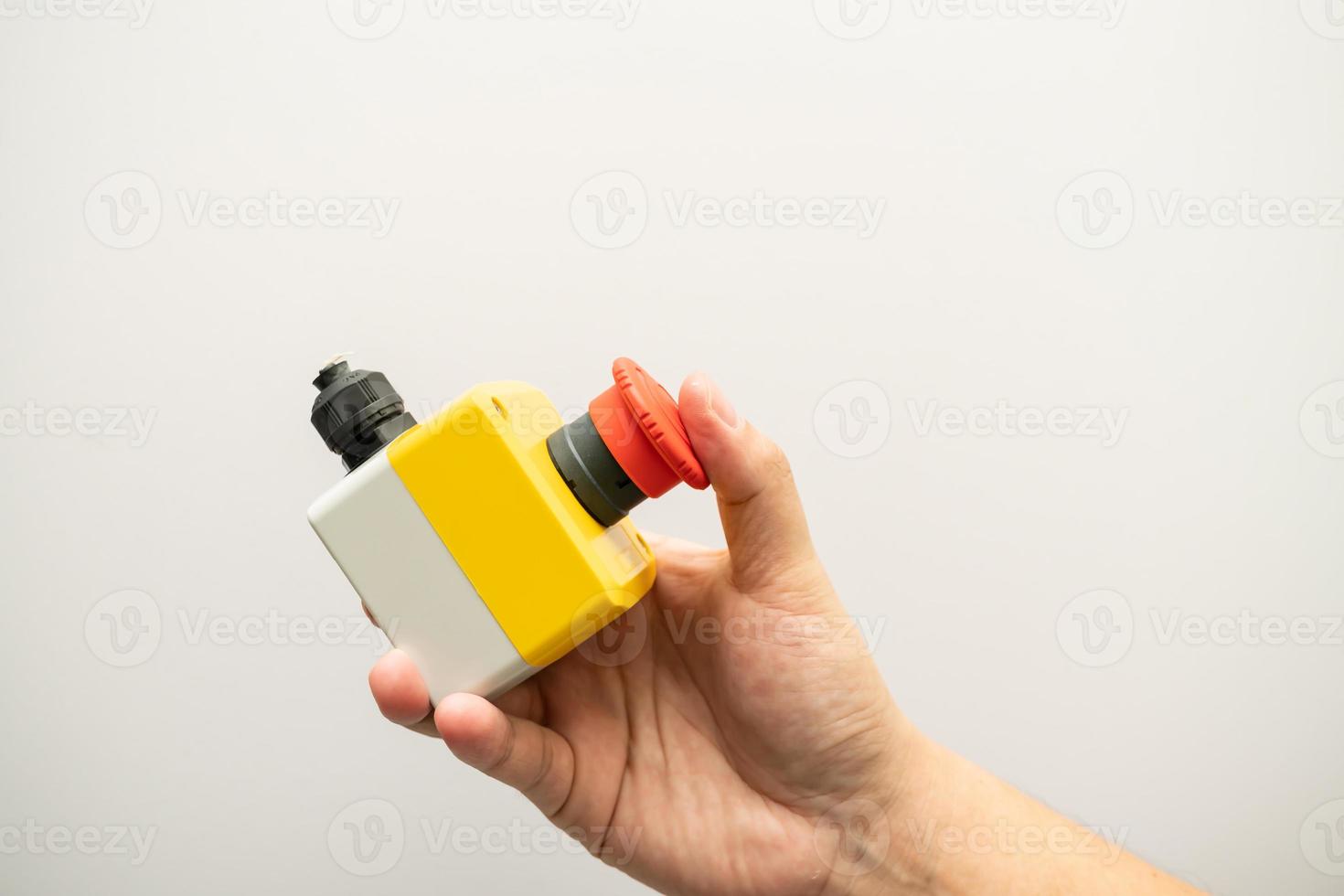 Stop Red Button and the Hand of Worker About to Press it. emergency stop button. Big Red emergency button or stop button for manual pressing. photo