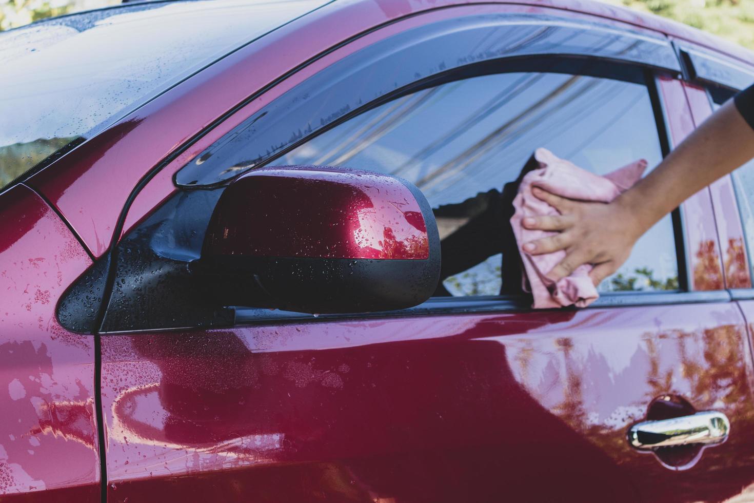 Car detailing - the man holds the microfiber in hand and polishes the car. Selective focus. photo