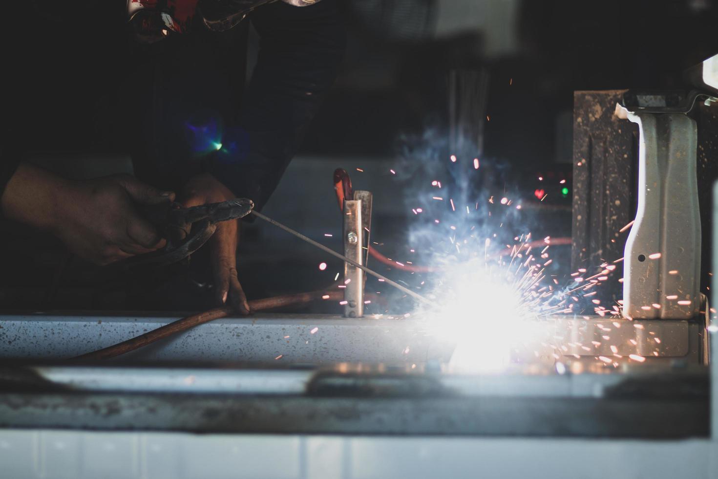 welder, welding automotive part in a car factory photo