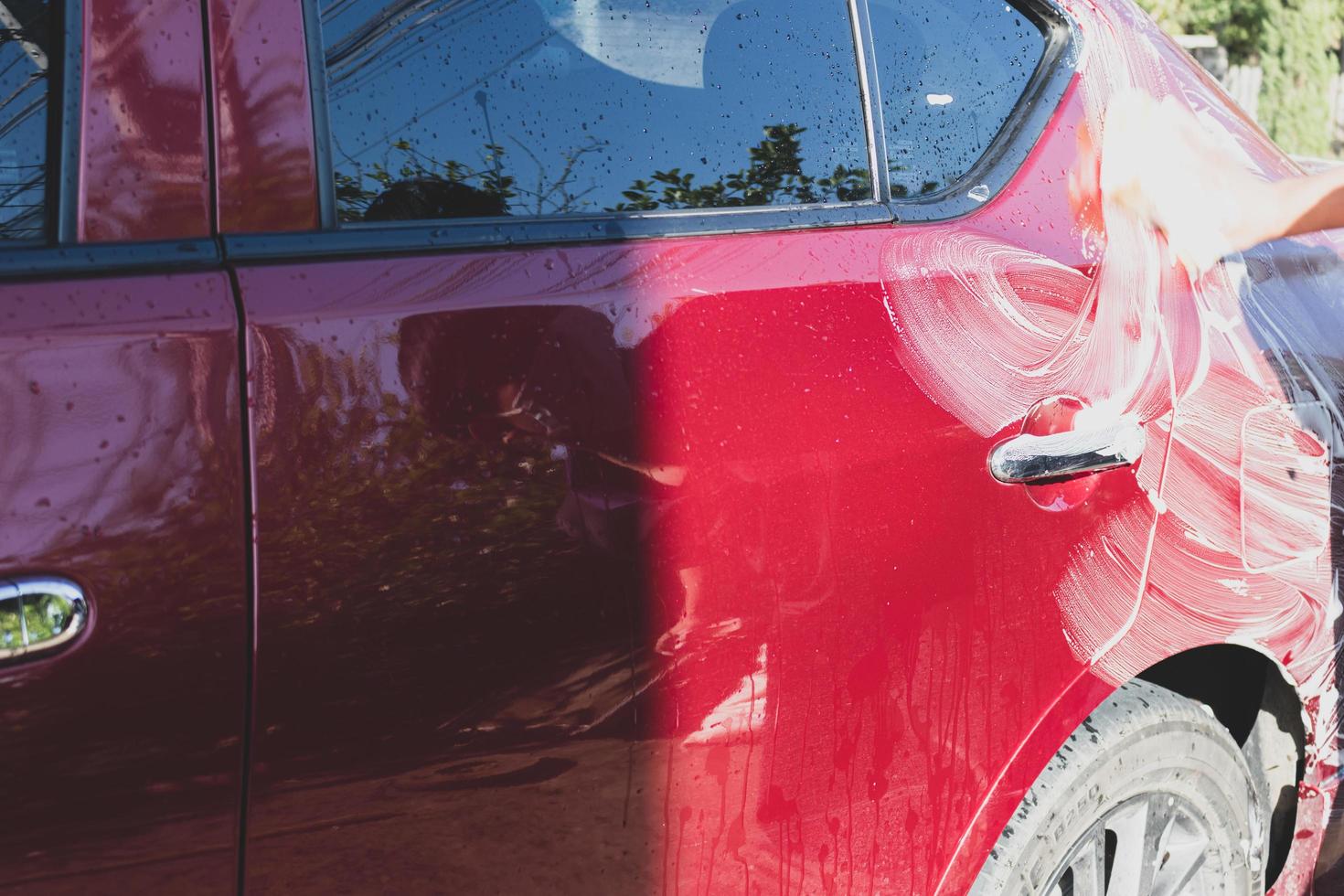 Car detailing - the man holds the microfiber in hand and polishes the car. Selective focus. photo