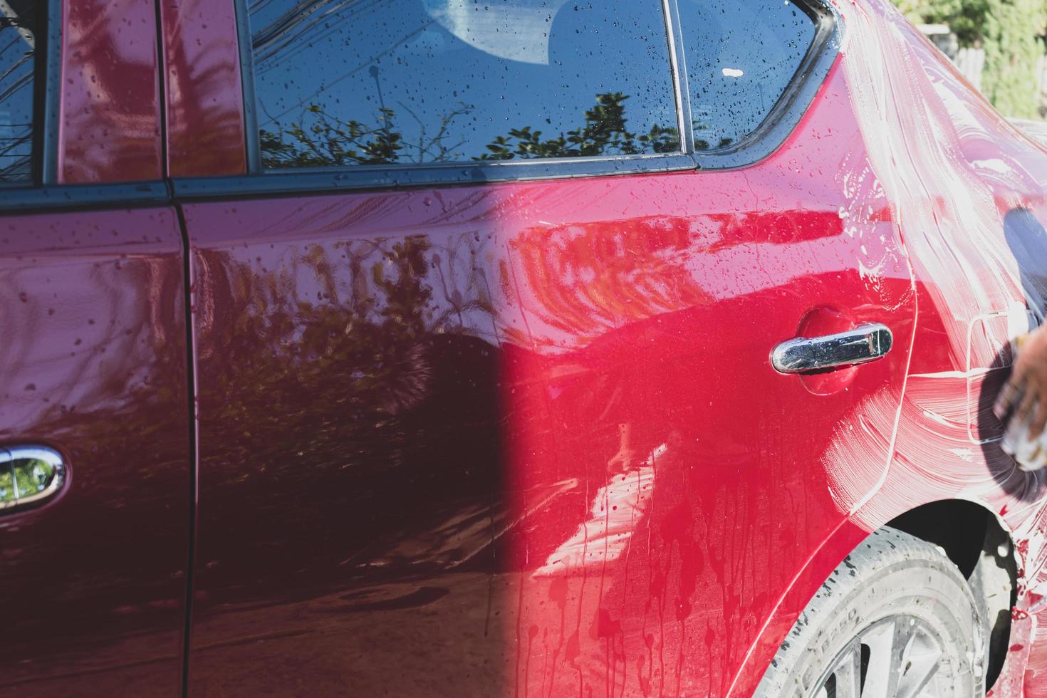 Car detailing - the man holds the microfiber in hand and polishes the car. Selective focus. photo