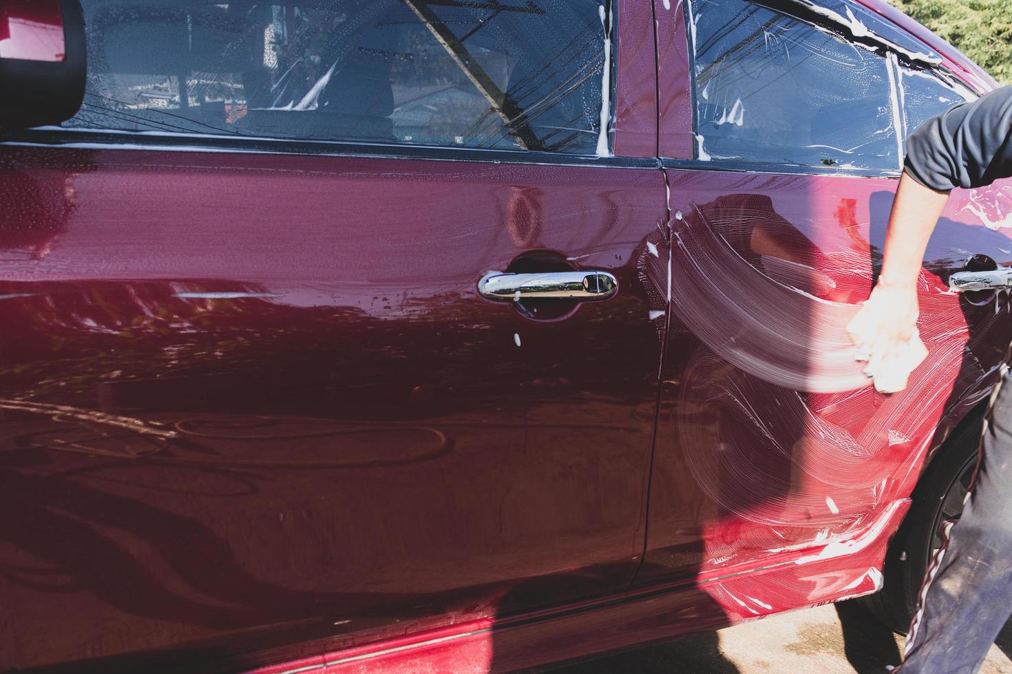 Car detailing - the man holds the microfiber in hand and polishes the car. Selective focus. photo