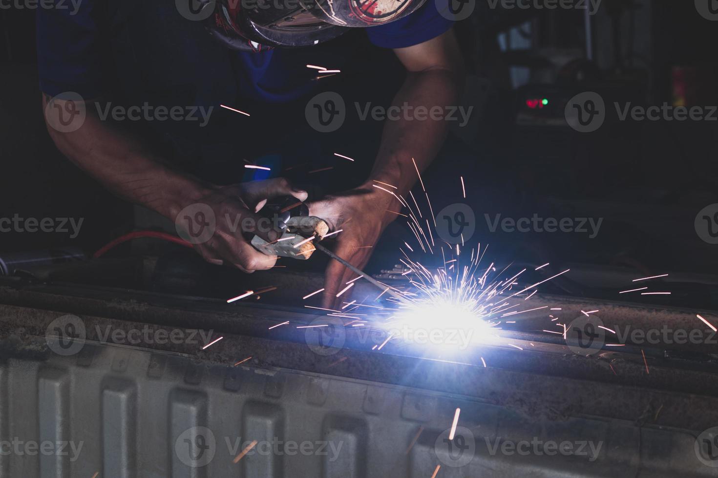 welder, welding automotive part in a car factory photo