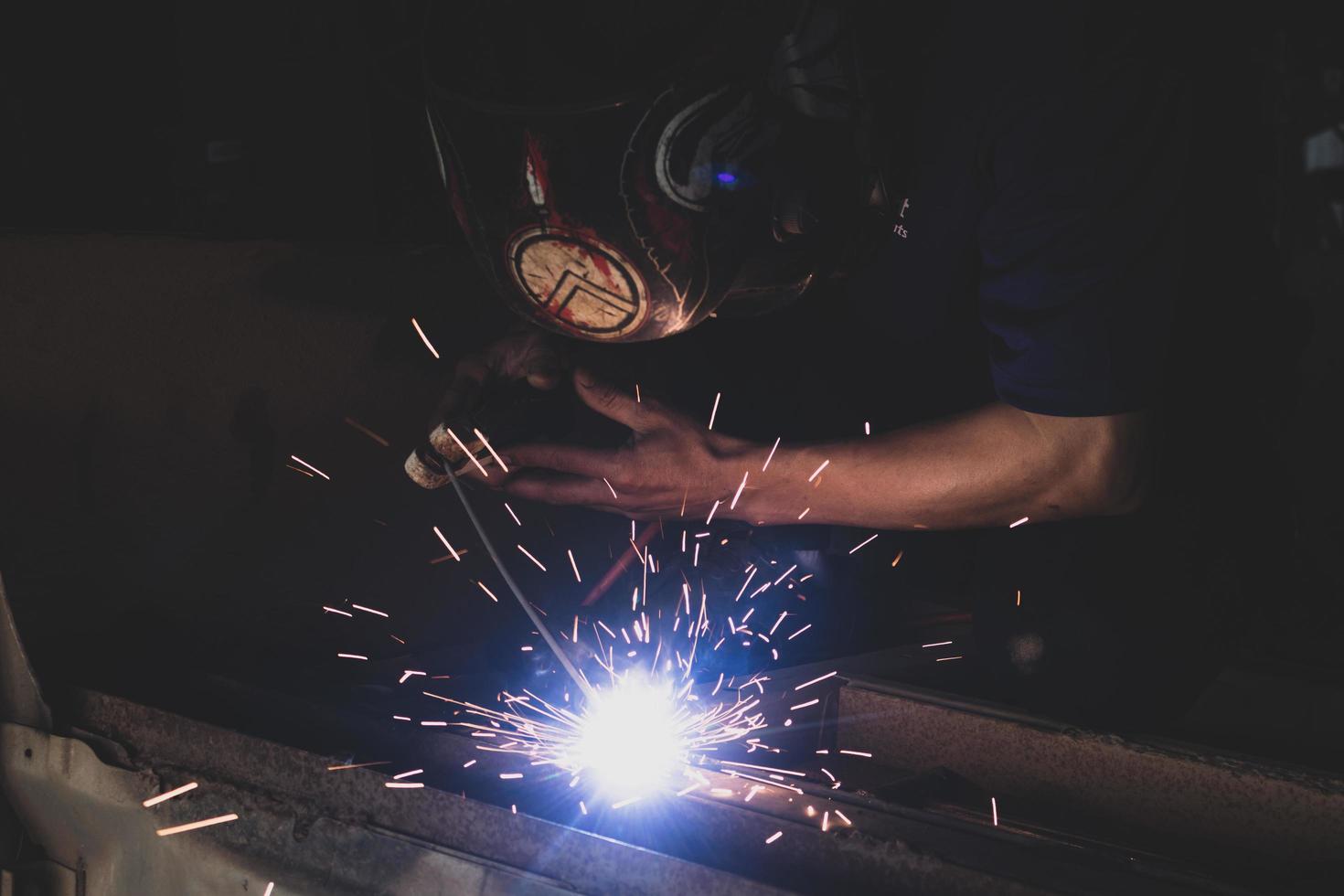 welder, welding automotive part in a car factory photo