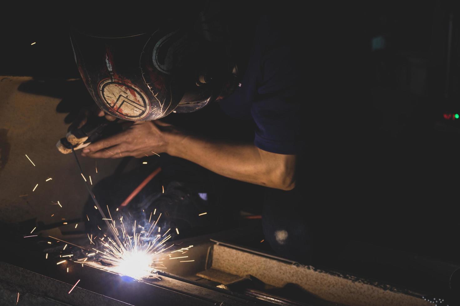 welder, welding automotive part in a car factory photo