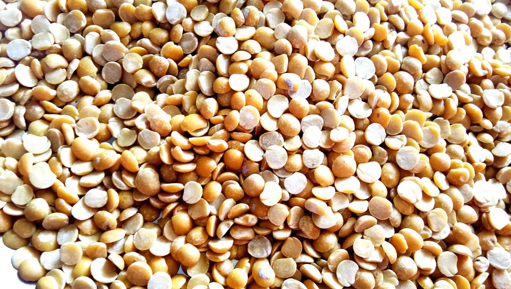 Macro closeup background texture of yellow chana split peas photo