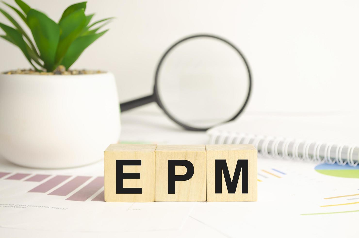 epm sign on wooden cubes and magnifier photo