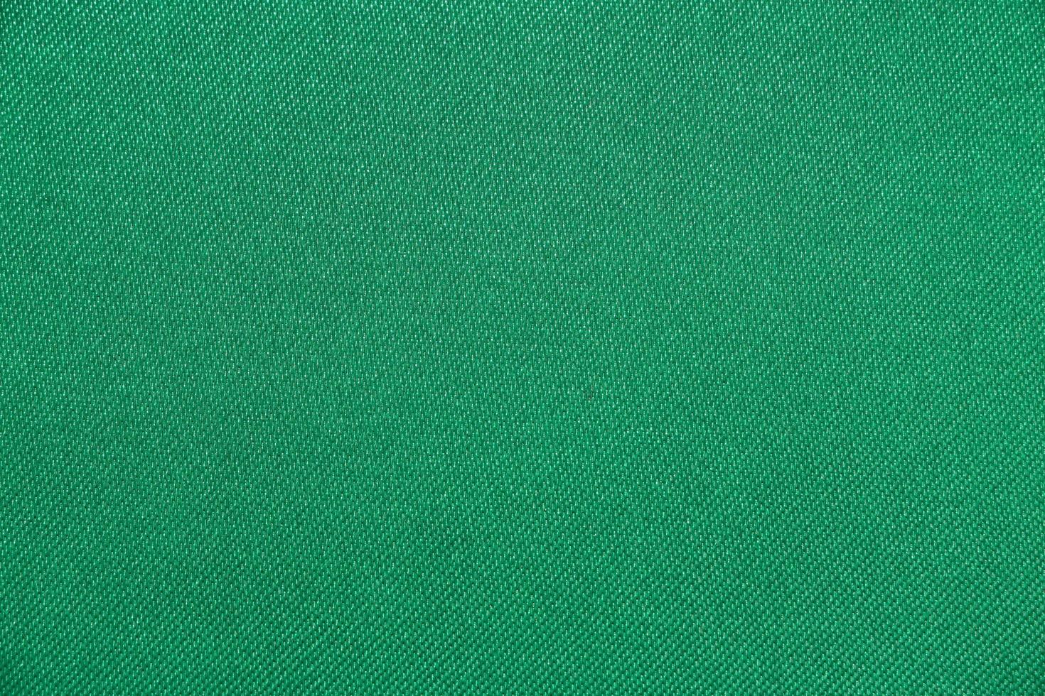 la textura del color verde de la tela tiene una superficie lisa, un fondo abstracto. foto