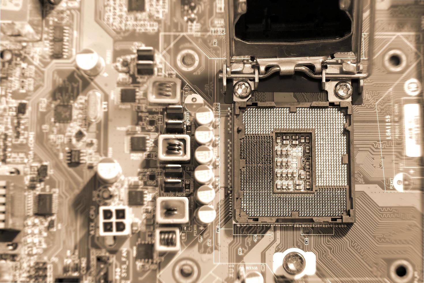 Electronic circuit boards on brown background with CPU socket, selective focus photo