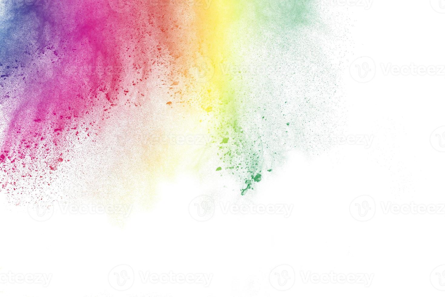 The explosion of colored powder. Beautiful powder fly away. The cloud of glowing color powder on white background photo