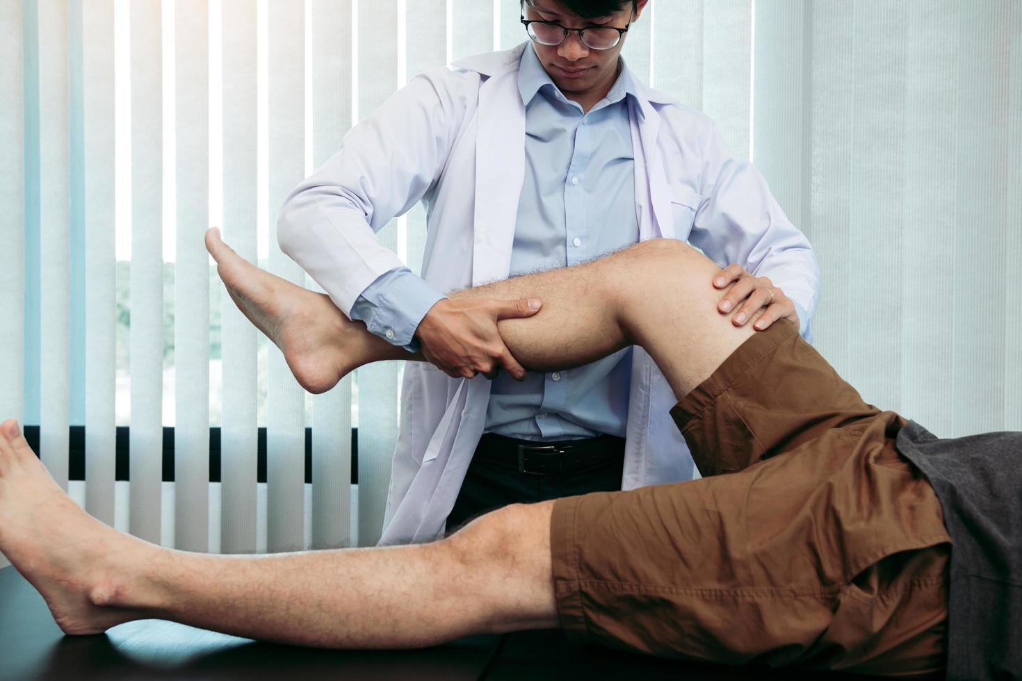 Physiotherapists are using the hands to grip the patient thigh to check for pain and massage in the clinic. photo