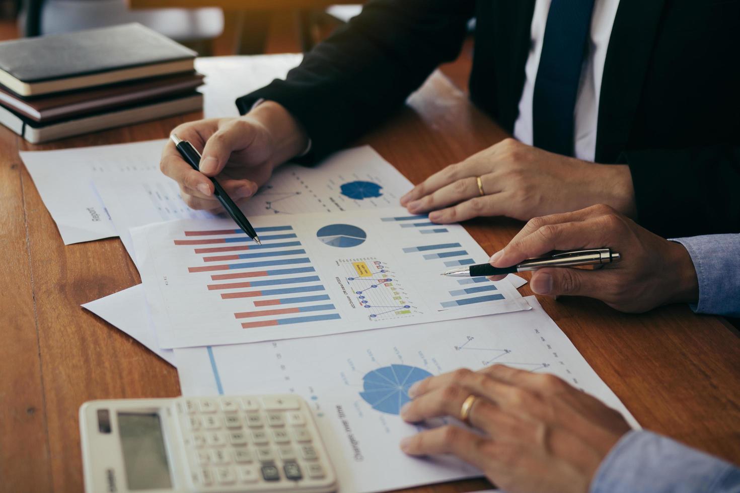 Colleagues are stress talking about the finance results report and compared with the financial information on the paperwork with analysis about planning in the future. photo