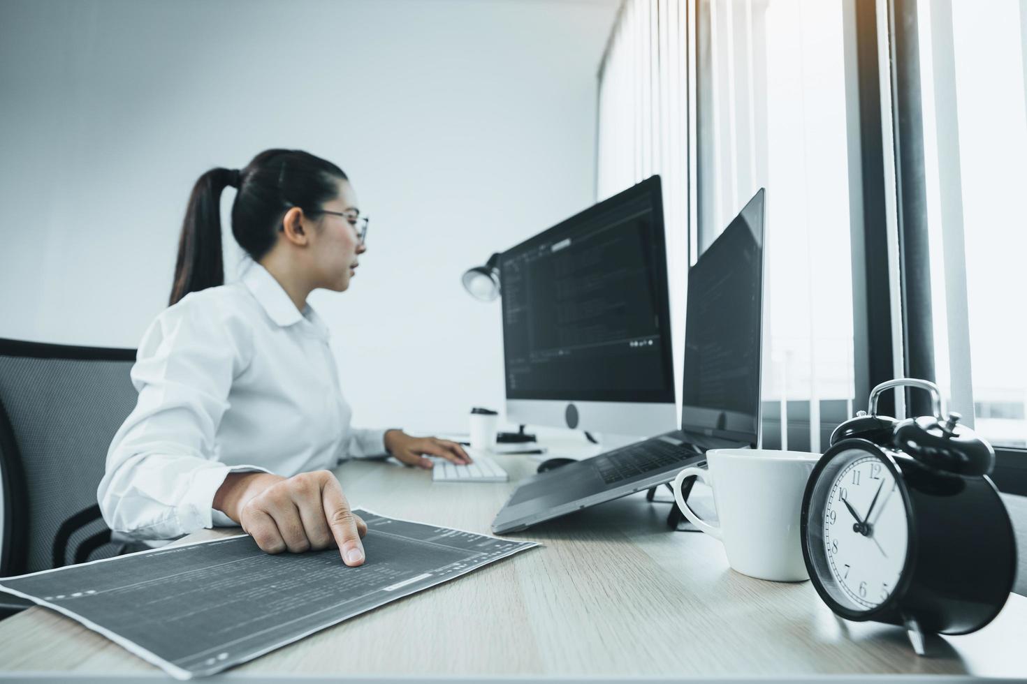 Software developers are analyzing about the code written into the program on the computer in office room. photo