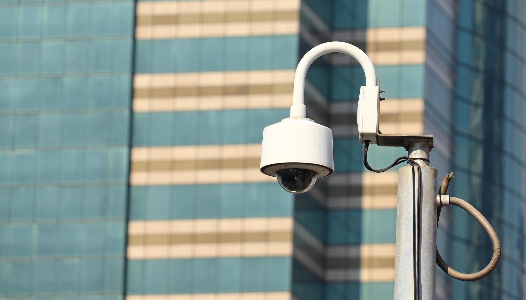 CCTV camera on bright blue sky background,  Concept. 24 hour day and night security photo