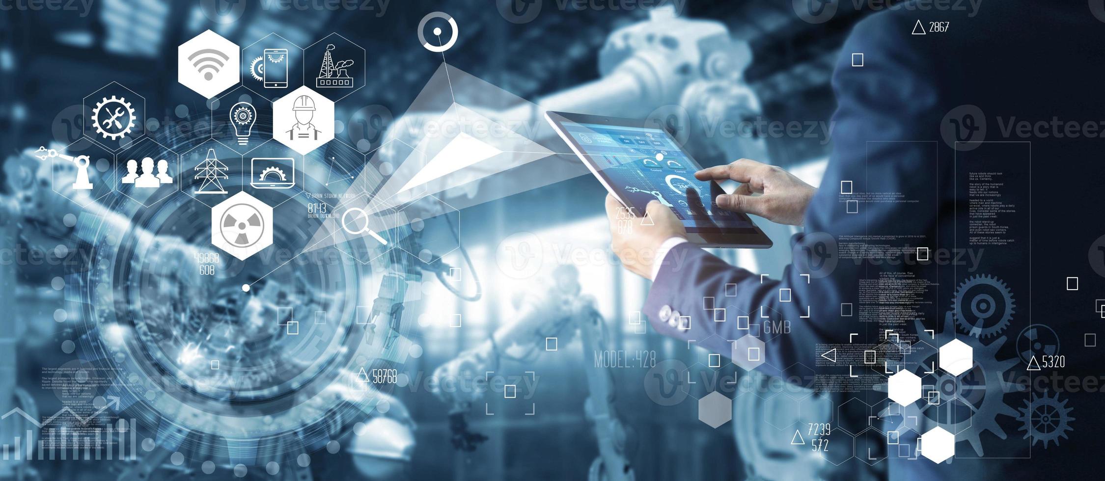Industrial Engineer controlling roboticts with monitoring system software and icon industry network connection on tablet. AI, Artificial Intelligence, Automation robot arm machine in smart factory. photo