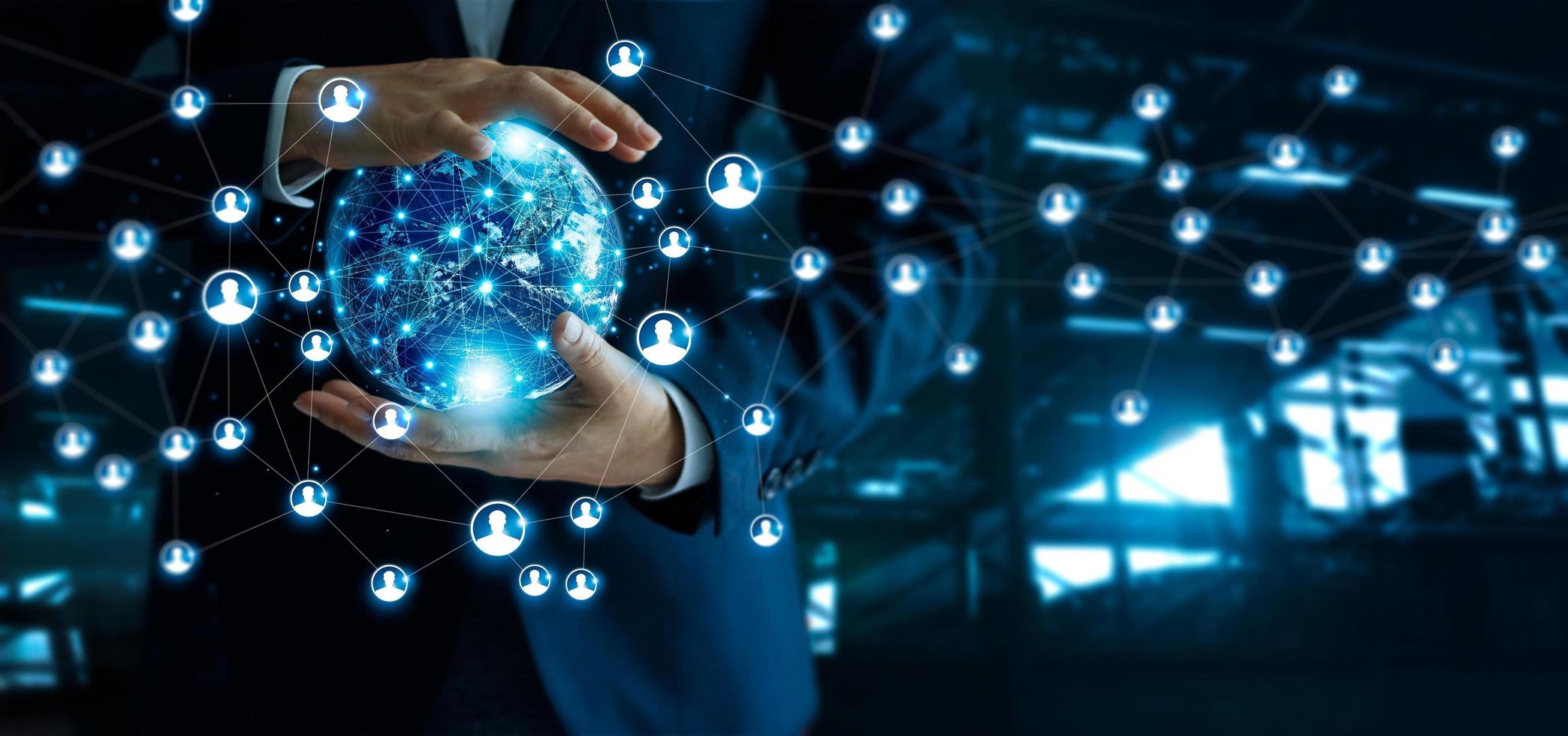 Businessman holding global customer network connection in hands.Technology  and structure networking and data exchanges communication on dark blue background. Elements of this image furnished by NASA photo