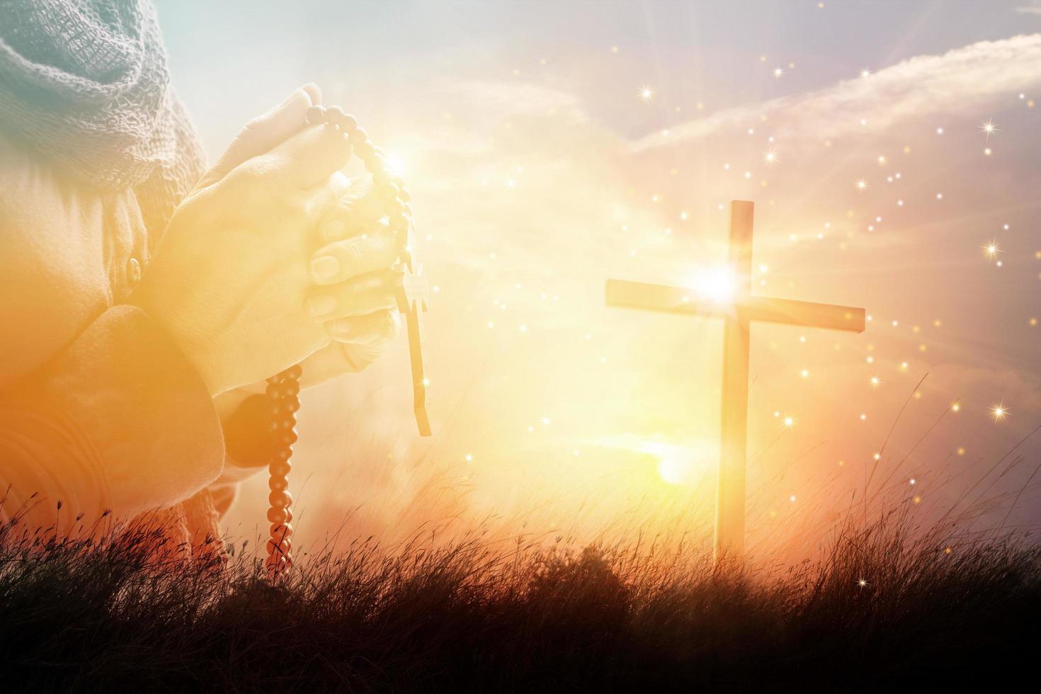 Double exposure. Woman praying with cross on nature sunset background, hope concept photo