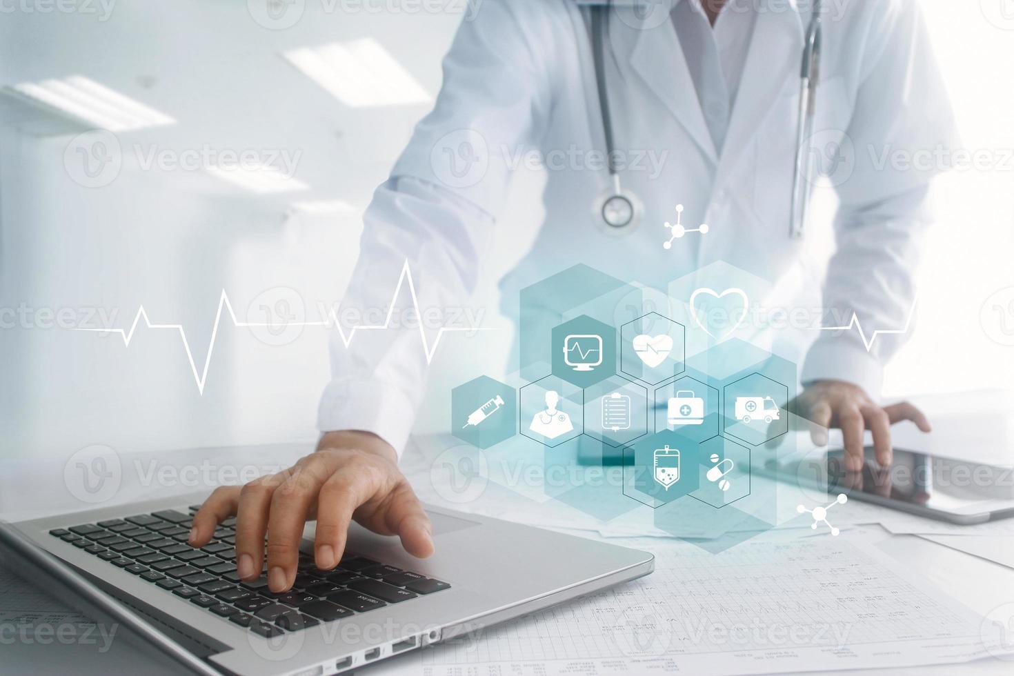 Medicine doctor hand touching laptop and tablet computer interface as medical network connection with icon modern on virtual screen, Digital healthcare, medical technology network. photo