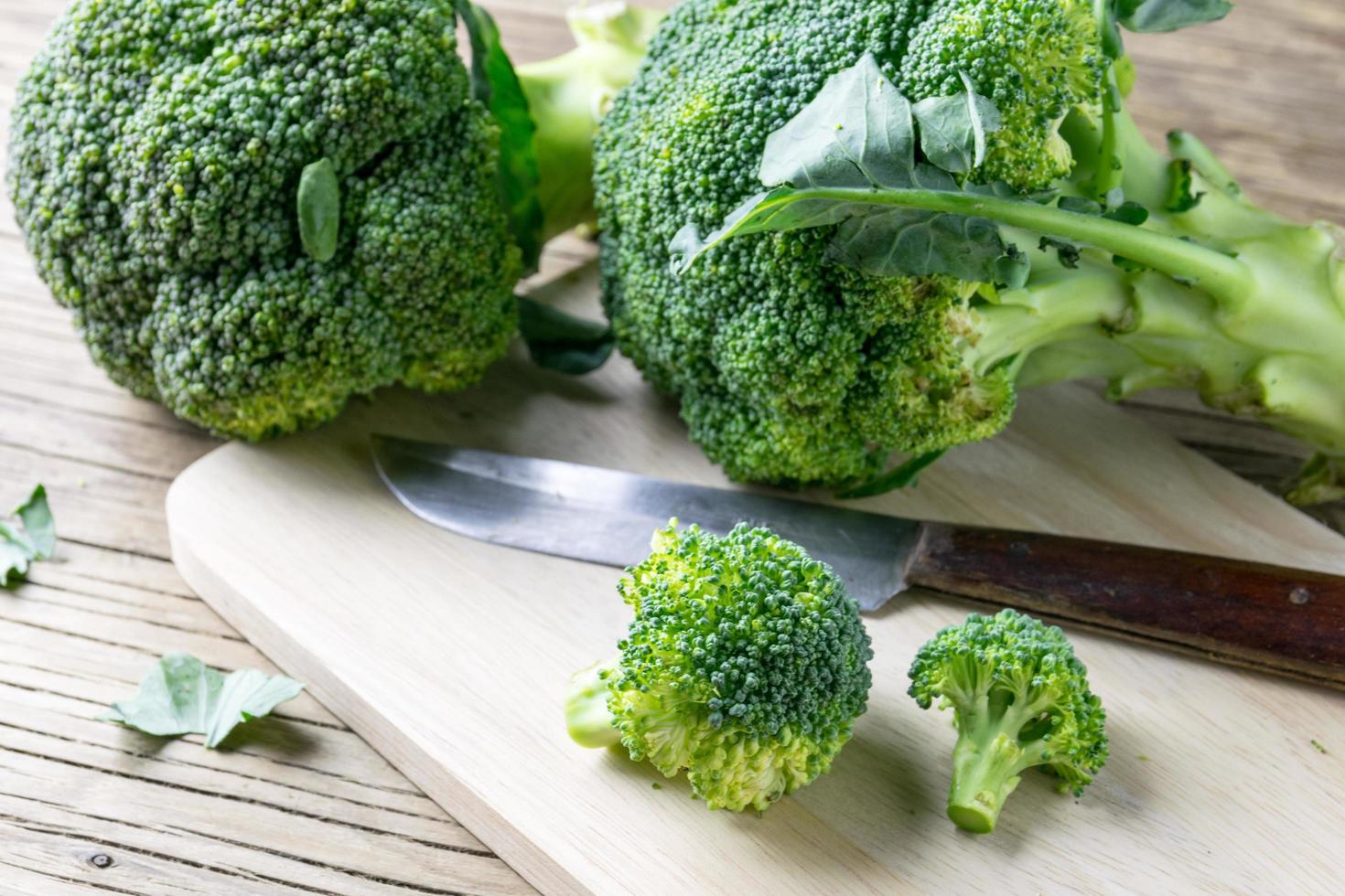 fresh broccoli on a cutting board and knife photo