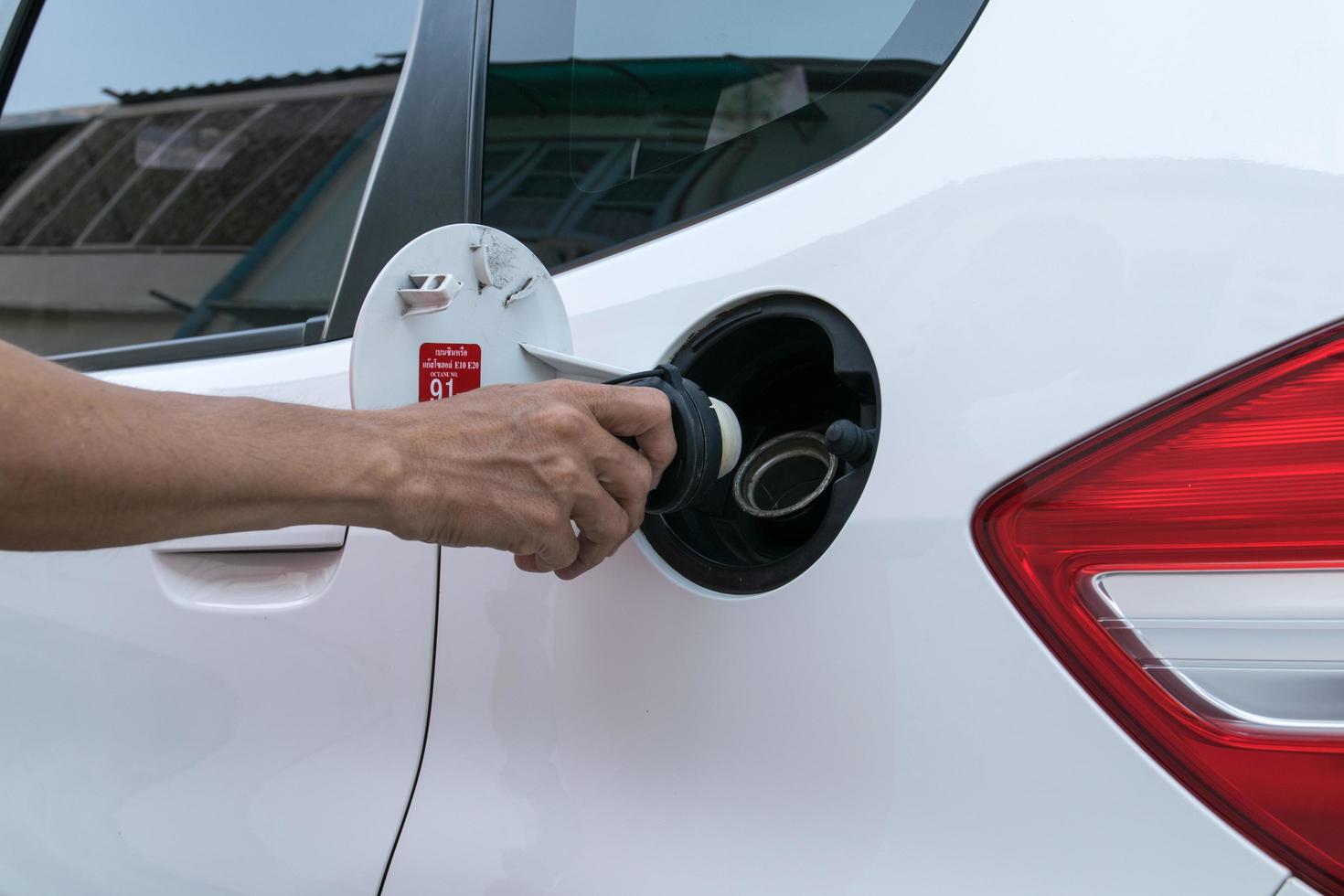 Hand opening the oil filler cap photo