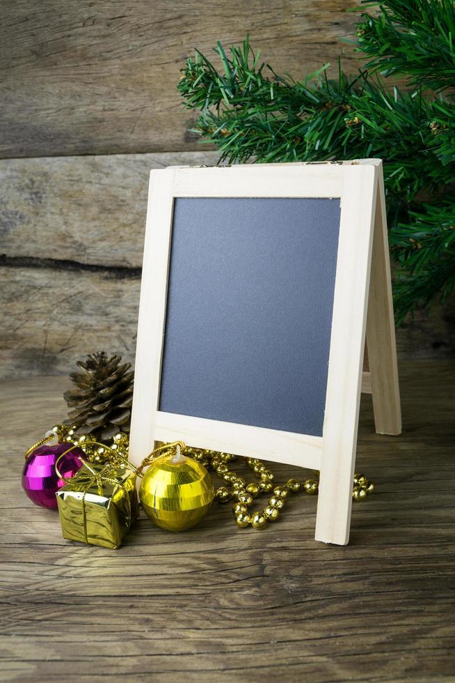 Picture Frame and Christmas decorations on old wooden background. photo