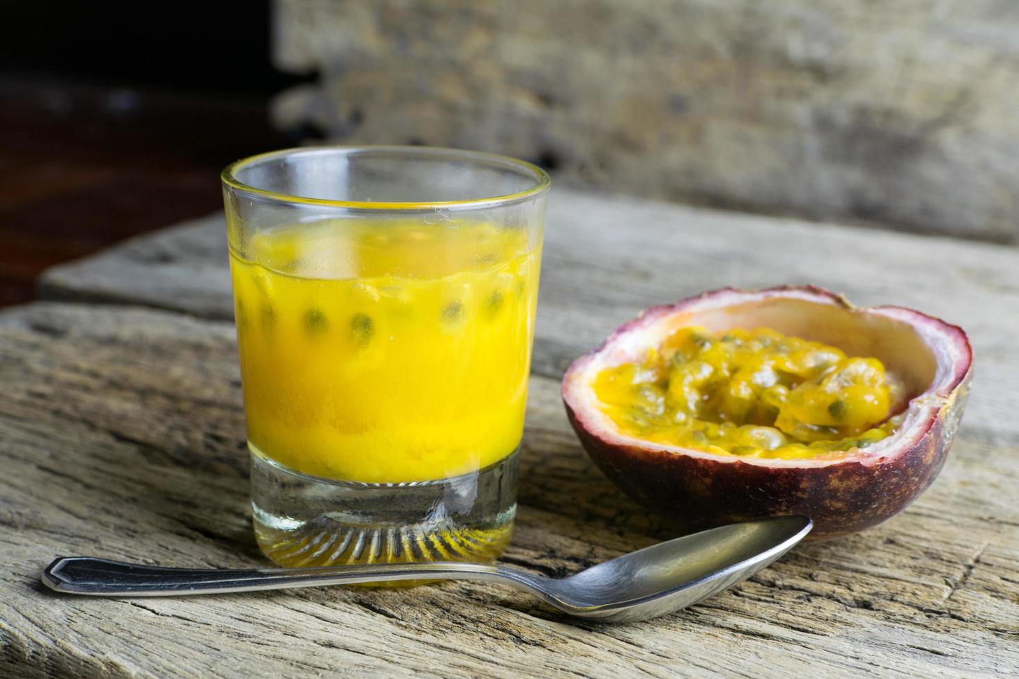 Passion fruits with glass of passion fruit juices on wooden photo