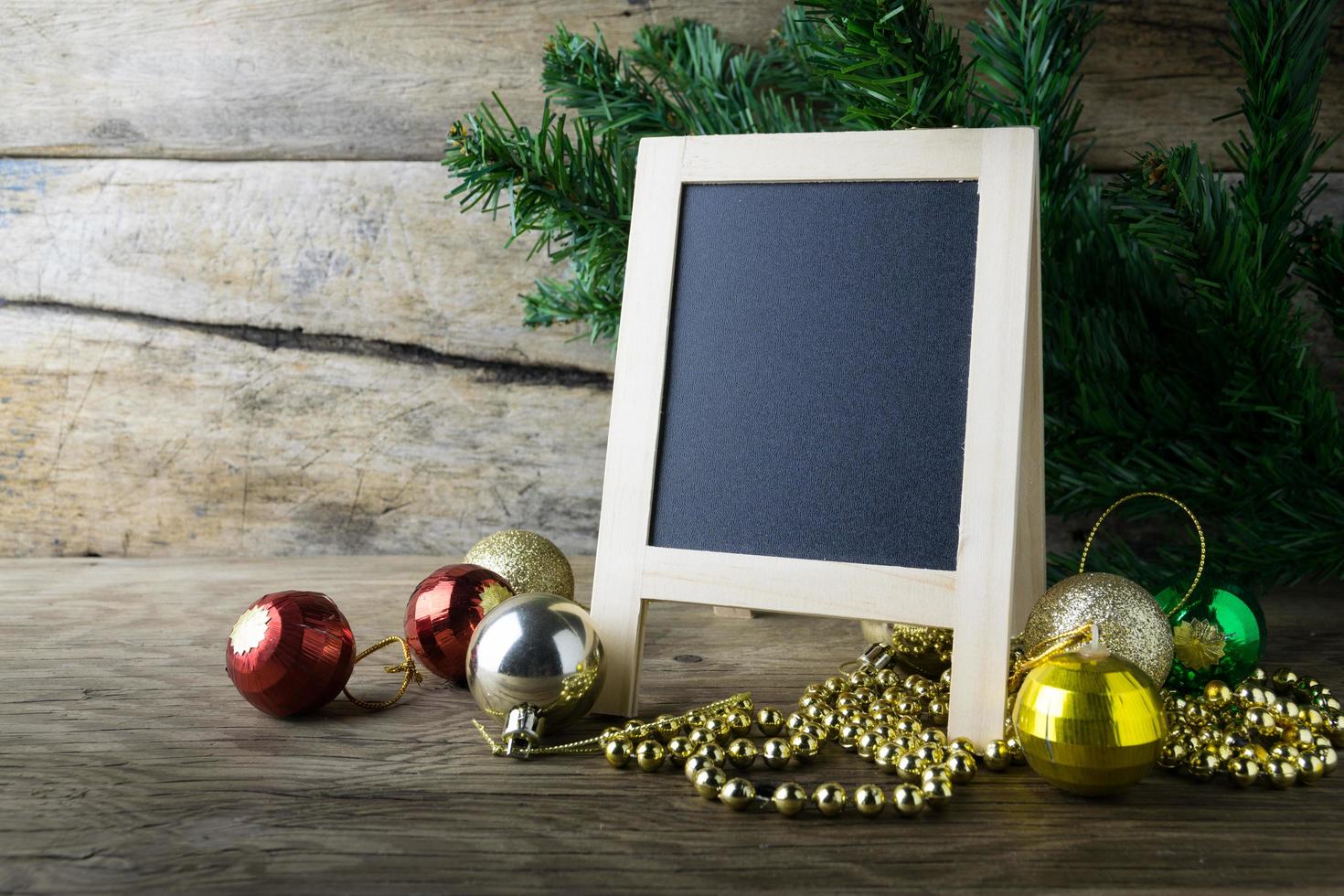 Picture Frame and Christmas decorations on old wooden background. photo