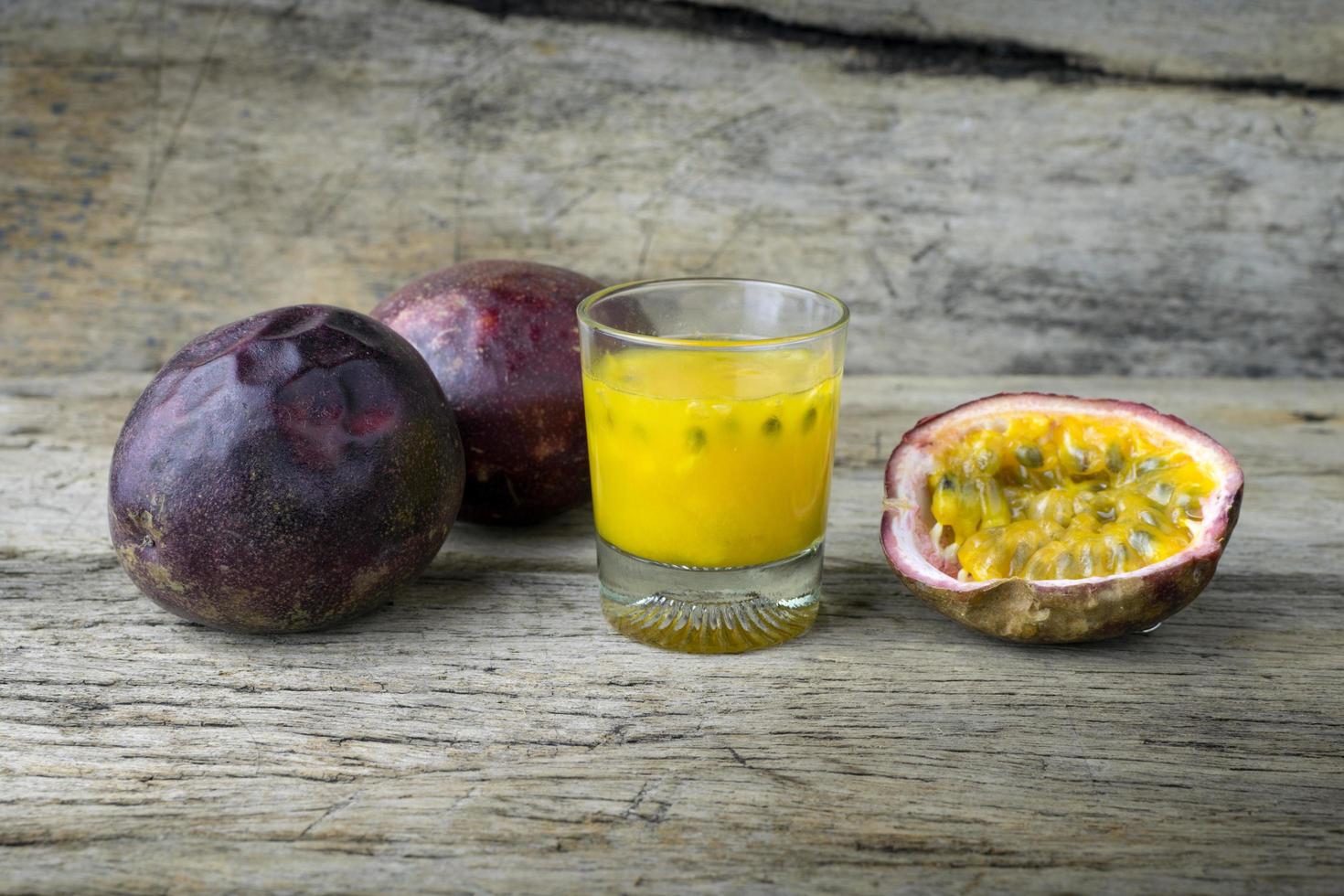 Passion fruits with glass of passion fruit juices on wooden photo
