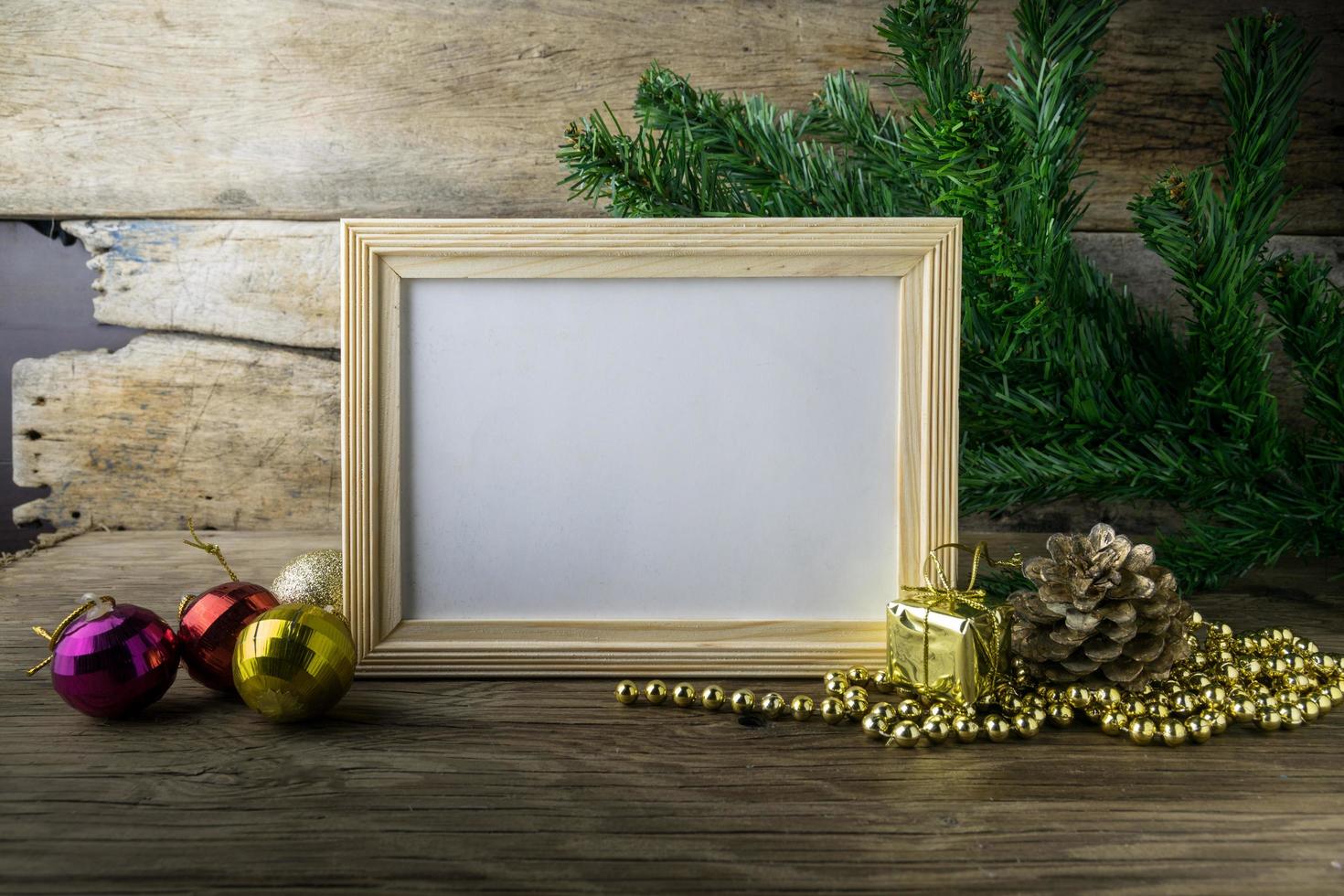 Picture Frame and Christmas decorations on old wooden background. photo