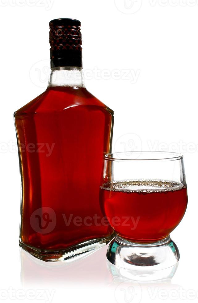 alcohol drink is in a bottle and glass photo