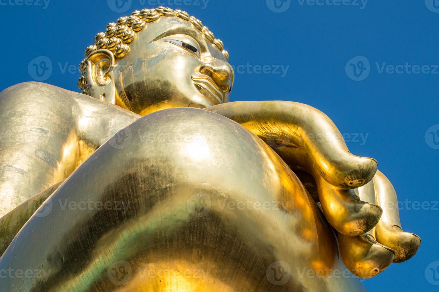 The big golden Buddha statue in Chiang Saen style located at the Golden triangle nearly Mekong river the border river between Thailand - Myanmar and Laos. photo