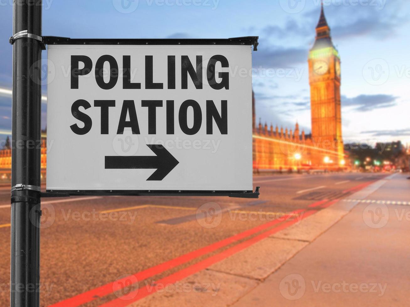 polling station sign over blurred parliament background photo