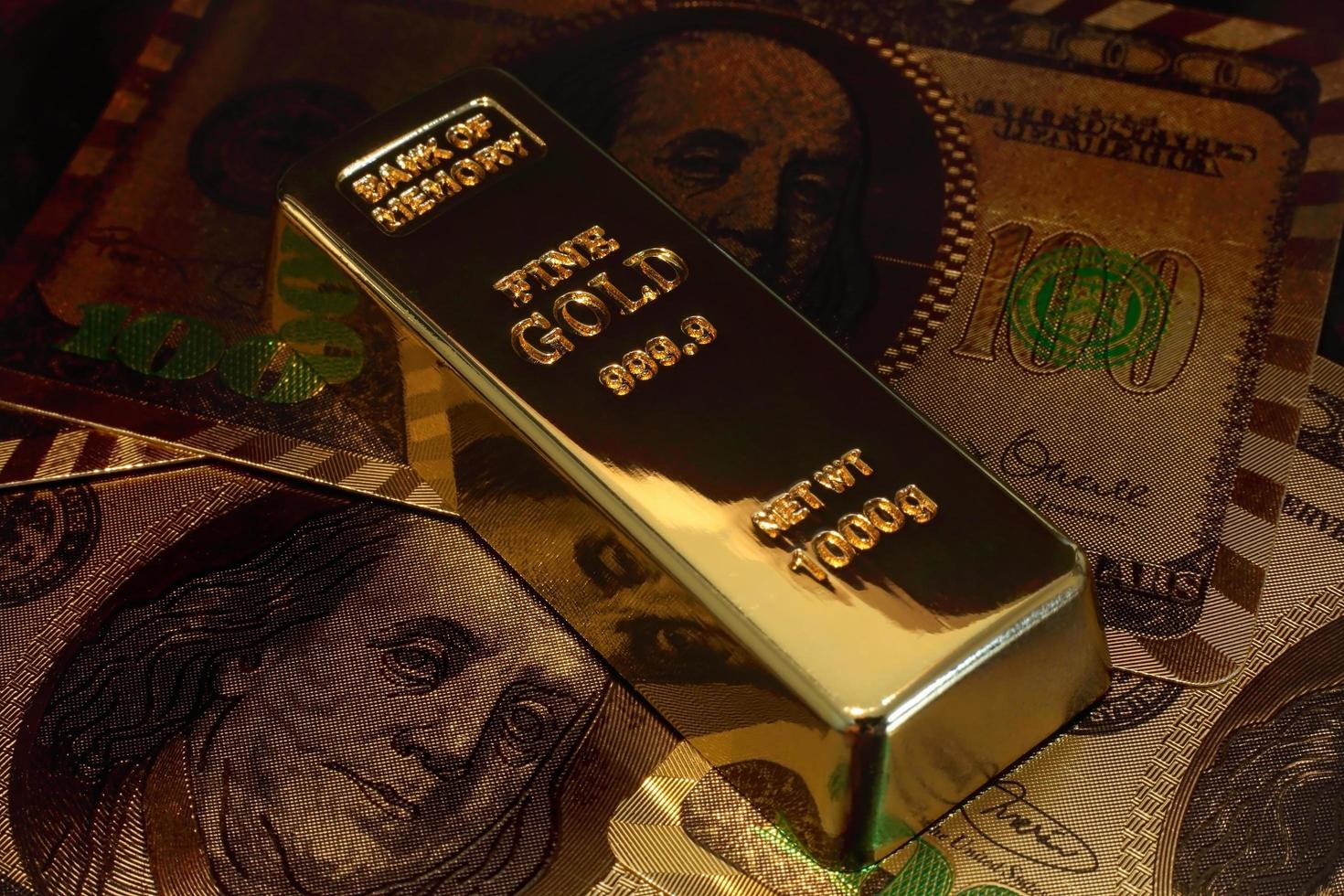 A Golden bar with dollar background. conceptual image or gold investment. photo