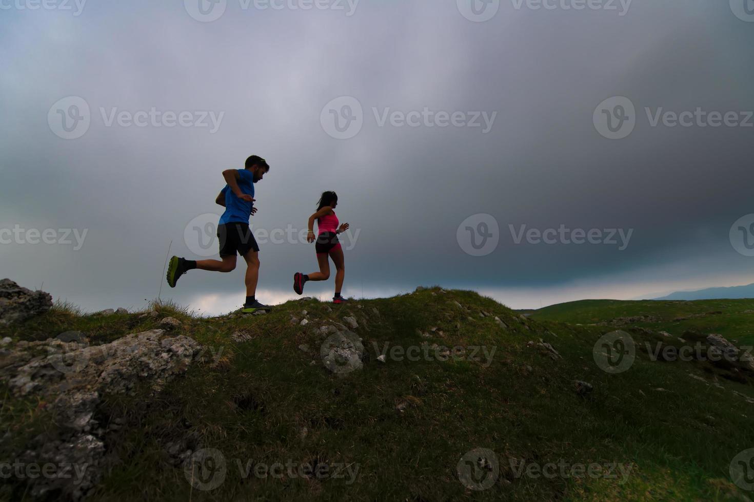 Sportive couple practice mountain trail running photo