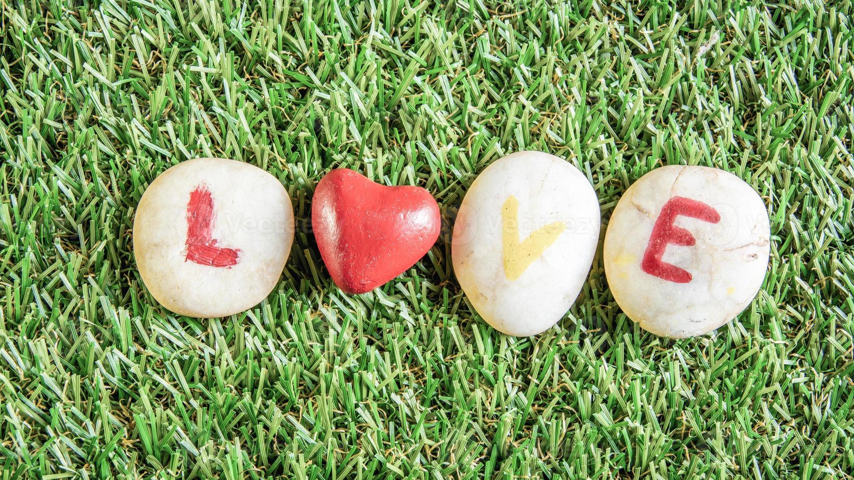 love paint on stone , on the grass photo