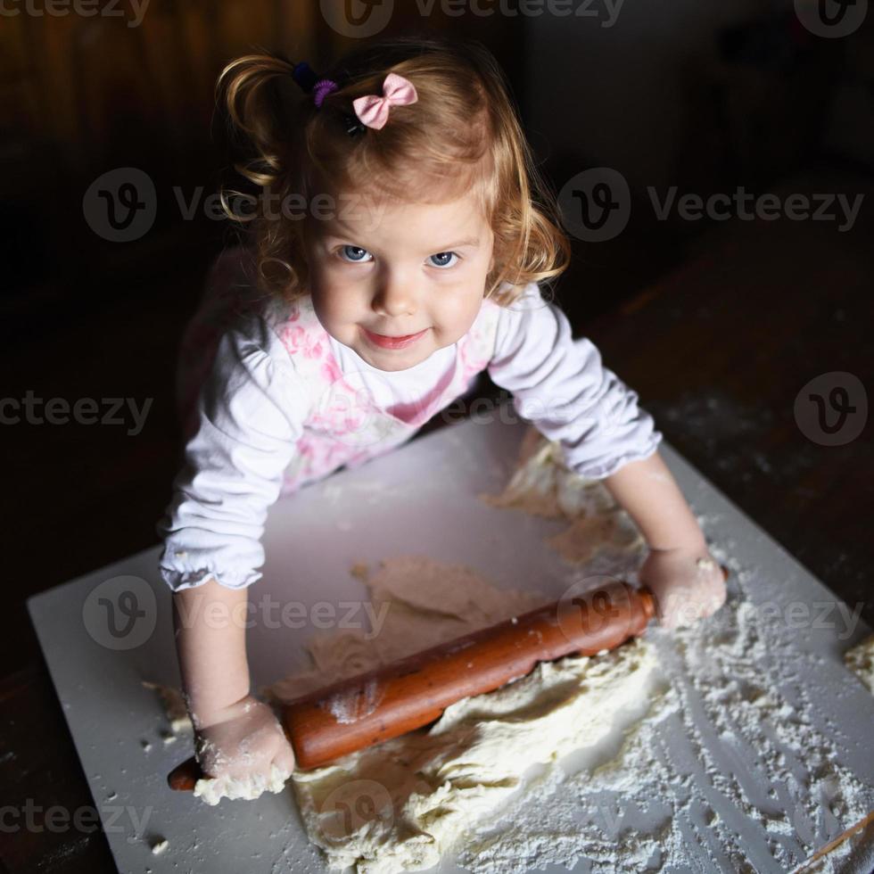 photo of  baker adorable, pretty little caucasian girl in chef.