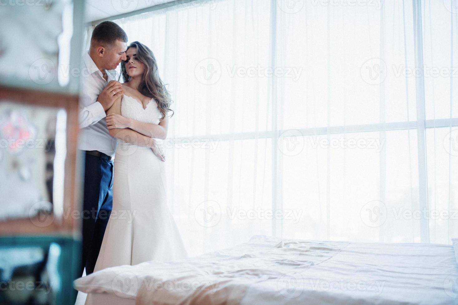 Wedding couple in hotel room photo